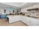Spacious kitchen with tiled countertops, white cabinetry, and breakfast bar at 4602 Inland Ct, Las Vegas, NV 89147
