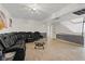 Expansive living room boasting wood look floors, an oversized sectional sofa, and a home theater setup, perfect for movie nights at 4602 Inland Ct, Las Vegas, NV 89147
