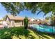 Backyard view shows a fenced in pool, grass area, shade trees, and the home's exterior at 4735 Roby Grey Way, North Las Vegas, NV 89081