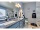Luxurious bathroom featuring double sinks, a marble shower, and modern fixtures at 4735 Roby Grey Way, North Las Vegas, NV 89081