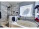 Bathroom featuring a shower, tub and marble tiling at 4735 Roby Grey Way, North Las Vegas, NV 89081