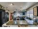 Updated kitchen featuring granite counters, stainless steel appliances, stylish backsplash, and painted cabinets at 4735 Roby Grey Way, North Las Vegas, NV 89081