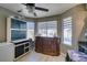 Bright kitchen features stainless steel appliances, natural light, and a modern ceiling fan at 4735 Roby Grey Way, North Las Vegas, NV 89081