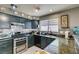 Updated kitchen featuring stainless steel appliances, granite countertops, and lots of natural light at 4735 Roby Grey Way, North Las Vegas, NV 89081