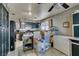 Kitchen boasts stainless steel appliances, modern backsplash, ample storage, and a breakfast bar at 4735 Roby Grey Way, North Las Vegas, NV 89081