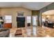 Spacious living room featuring tile floors, a ceiling fan, and an arched entrance to the dining room at 4735 Roby Grey Way, North Las Vegas, NV 89081