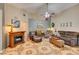 Comfortable living room featuring patterned tile flooring, a ceiling fan, and a fireplace with a wood mantel at 4735 Roby Grey Way, North Las Vegas, NV 89081