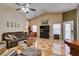 Cozy living room with tile flooring, a ceiling fan, and two windows at 4735 Roby Grey Way, North Las Vegas, NV 89081