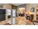 Open-concept living room features patterned tile flooring and an arched entrance into the dining room at 4735 Roby Grey Way, North Las Vegas, NV 89081