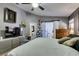 Comfortable main bedroom featuring a ceiling fan and dresser with a TV at 4735 Roby Grey Way, North Las Vegas, NV 89081
