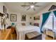 Cozy main bedroom featuring a ceiling fan, hardwood floors, and bright natural light at 4735 Roby Grey Way, North Las Vegas, NV 89081