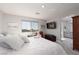 Serene bedroom with a plush bed, a cozy sitting area, and a glimpse of the en-suite bathroom for added convenience at 494 Mahogany Ridge St, Las Vegas, NV 89138