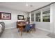 Bright dining area featuring wood table, blue chairs, and large windows letting in natural light at 494 Mahogany Ridge St, Las Vegas, NV 89138