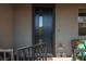 Inviting front porch featuring a black front door, cute decor and a welcome sign at 494 Mahogany Ridge St, Las Vegas, NV 89138
