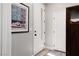 Bright hallway featuring neutral paint, a stylish picture, and several doors at 494 Mahogany Ridge St, Las Vegas, NV 89138