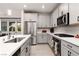 Stylish kitchen with stainless steel appliances, gray cabinets, and ample counter space at 494 Mahogany Ridge St, Las Vegas, NV 89138