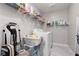 Functional laundry room with washer, dryer, storage shelves, and ample space for sorting and folding laundry at 494 Mahogany Ridge St, Las Vegas, NV 89138