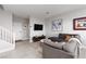 Cozy living room with a gray sectional sofa, tv, and nearby staircase at 494 Mahogany Ridge St, Las Vegas, NV 89138