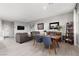 Open-concept living area with gray sofa, wood floors, and dining space at 494 Mahogany Ridge St, Las Vegas, NV 89138