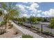 Street view of a walkable community with a sidewalk, shrubs, and street lights at 494 Mahogany Ridge St, Las Vegas, NV 89138