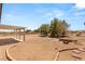 Large backyard includes a covered patio and mature trees at 5085 Raven Ave, Las Vegas, NV 89139