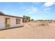 A view of the backyard with gravel and desert landscaping at 5085 Raven Ave, Las Vegas, NV 89139