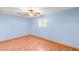 Bedroom with blue walls, wood floor, and window with shutters at 5085 Raven Ave, Las Vegas, NV 89139