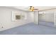 Bright bedroom with shuttered window, blue carpet and large mirrored closet at 5085 Raven Ave, Las Vegas, NV 89139