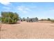 Rear exterior showcases the home with covered patio and expansive yard at 5085 Raven Ave, Las Vegas, NV 89139