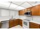 Bright kitchen featuring tile floor, stainless steel dishwasher, and white countertops and appliances at 5085 Raven Ave, Las Vegas, NV 89139