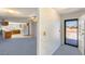 Open-concept living space with kitchen view and ample natural light from the front door at 5085 Raven Ave, Las Vegas, NV 89139