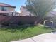 Lush backyard with green grass, mature landscaping, and a charming soccer net at 5852 Clear Haven Ln, North Las Vegas, NV 89081