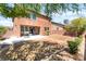 Spacious backyard with a concrete patio, mature trees, and a well-maintained brick fence at 5852 Clear Haven Ln, North Las Vegas, NV 89081