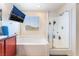Bright bathroom with a separate shower, soaking tub and a mounted flat screen television at 5852 Clear Haven Ln, North Las Vegas, NV 89081