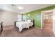 Stylish bedroom featuring a green accent wall and plush carpeting, creating a cozy and inviting atmosphere at 5852 Clear Haven Ln, North Las Vegas, NV 89081