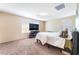 Comfortable bedroom with large windows, plush carpeting, and a flat-screen TV at 5852 Clear Haven Ln, North Las Vegas, NV 89081