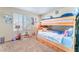 Charming bedroom with a wooden bunk bed, a bright window, and fun decorative elements at 5852 Clear Haven Ln, North Las Vegas, NV 89081