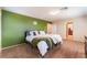 Comfortable bedroom with a striking green accent wall, plush carpeting, and ample natural light at 5852 Clear Haven Ln, North Las Vegas, NV 89081