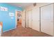 Bright bedroom showcasing a closet with sliding doors, a doorway, and a calming blue accent wall at 5852 Clear Haven Ln, North Las Vegas, NV 89081