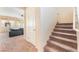 Inviting entryway featuring a staircase and a glimpse into the cozy living room with plush seating at 5852 Clear Haven Ln, North Las Vegas, NV 89081