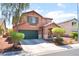 Inviting two-story home featuring a well-maintained yard, desert landscaping, and an attached two-car garage at 5852 Clear Haven Ln, North Las Vegas, NV 89081