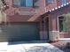 Two-story home with a gray garage door, archway, and desert landscaping at 5852 Clear Haven Ln, North Las Vegas, NV 89081
