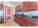 Cherry-wood kitchen cabinets with stainless steel appliances and granite countertops at 5852 Clear Haven Ln, North Las Vegas, NV 89081