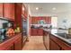 Cherry-wood kitchen cabinets with granite countertops and stainless steel appliances at 5852 Clear Haven Ln, North Las Vegas, NV 89081