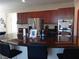 Kitchen featuring a large island with granite countertops and stainless steel appliances at 5852 Clear Haven Ln, North Las Vegas, NV 89081