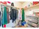 Functional walk-in closet featuring a variety of clothing and organizing accessories on shelving units at 5852 Clear Haven Ln, North Las Vegas, NV 89081