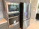 Stainless steel appliances including built-in microwave and oven, and refrigerator enhancing this modern kitchen at 6511 Dove Point Pl, Las Vegas, NV 89130
