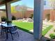 Inviting backyard with artificial turf, a fire pit, and stylish outdoor seating at 6511 Dove Point Pl, Las Vegas, NV 89130