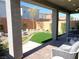 Charming backyard with artificial grass, patio, and inviting outdoor seating areas at 6511 Dove Point Pl, Las Vegas, NV 89130