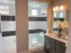 Modern bathroom featuring glass enclosed shower, gray cabinets and contemporary fixtures and a clean aesthetic at 6511 Dove Point Pl, Las Vegas, NV 89130